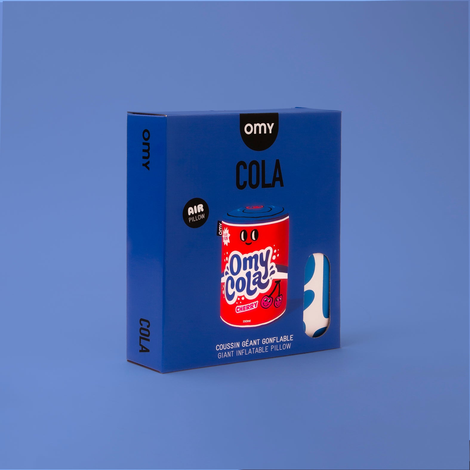 Packaging du coussin gonflable OMY Cola – Boîte bleue au design pop