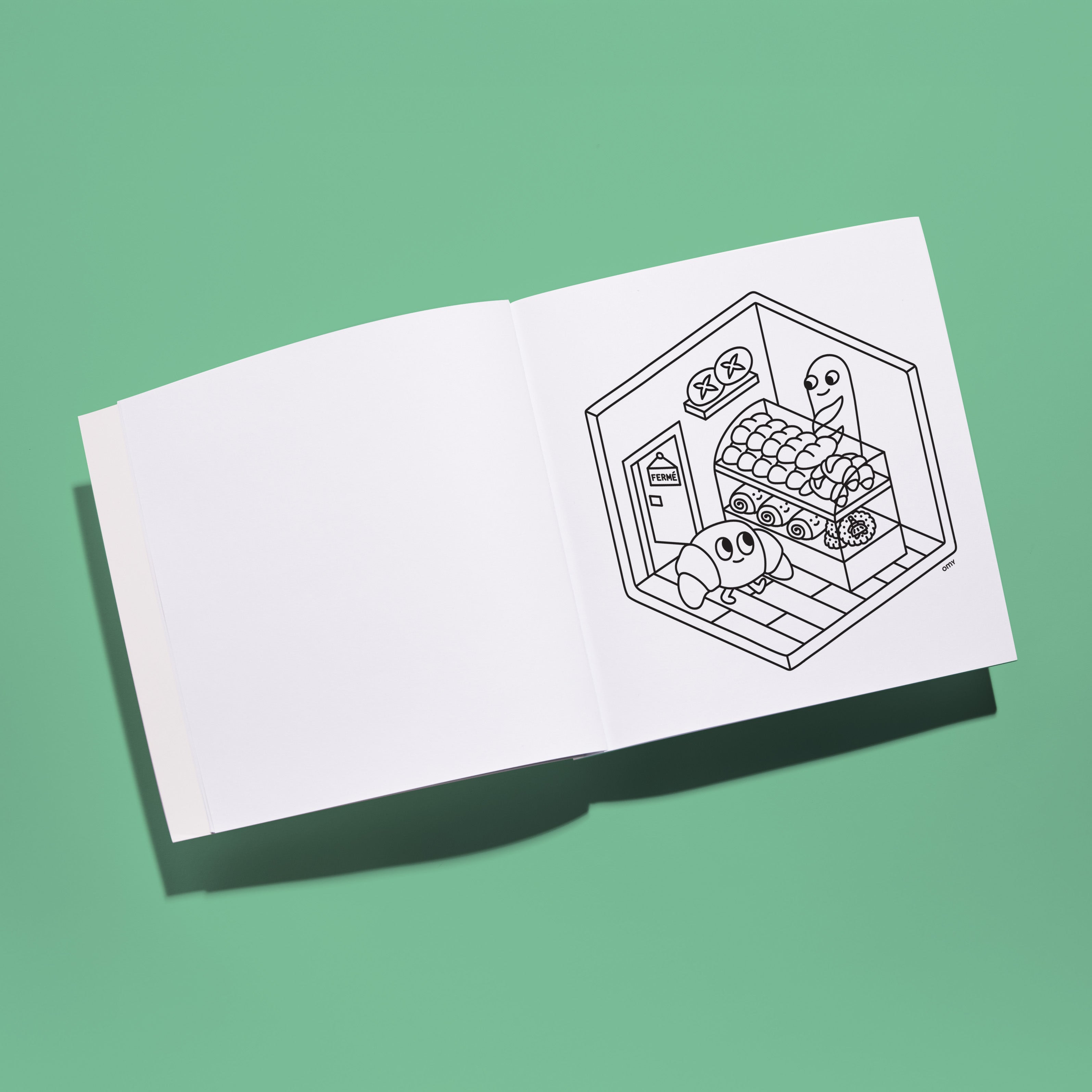 Page intérieure du cahier de coloriage OMY Cozy Art Paris – illustration en noir et blanc d’une boulangerie avec des personnages croissants mignons – carnet créatif et apaisant pour enfants et adultes