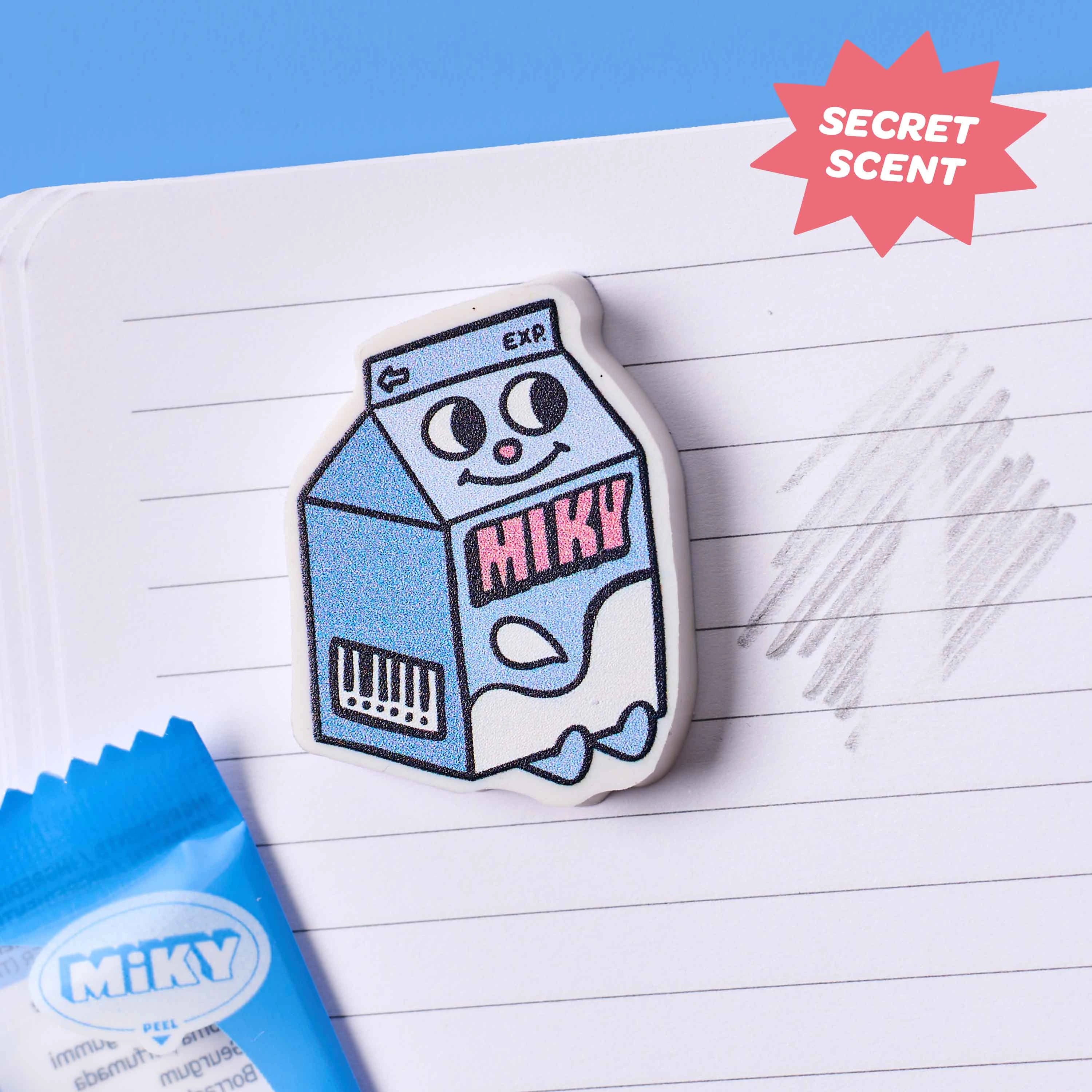 Gomme Miky OMY en forme de lait utilisée sur un carnet avec effet effaçable