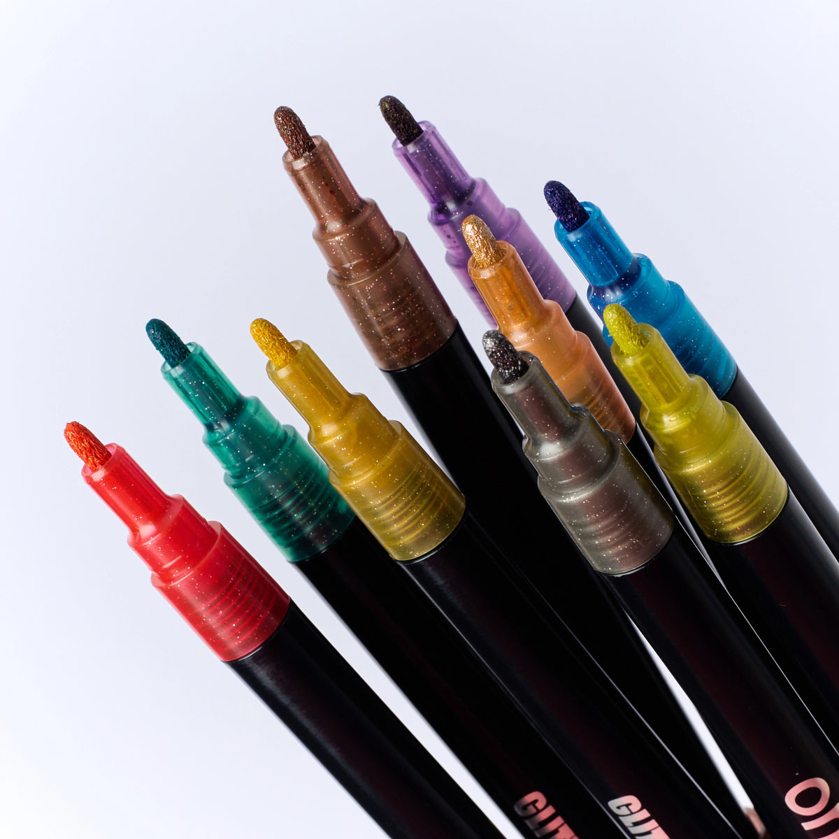 Gros plan sur les pointes et les 9 couleurs des feutres pailletés Glitter Club OMY.