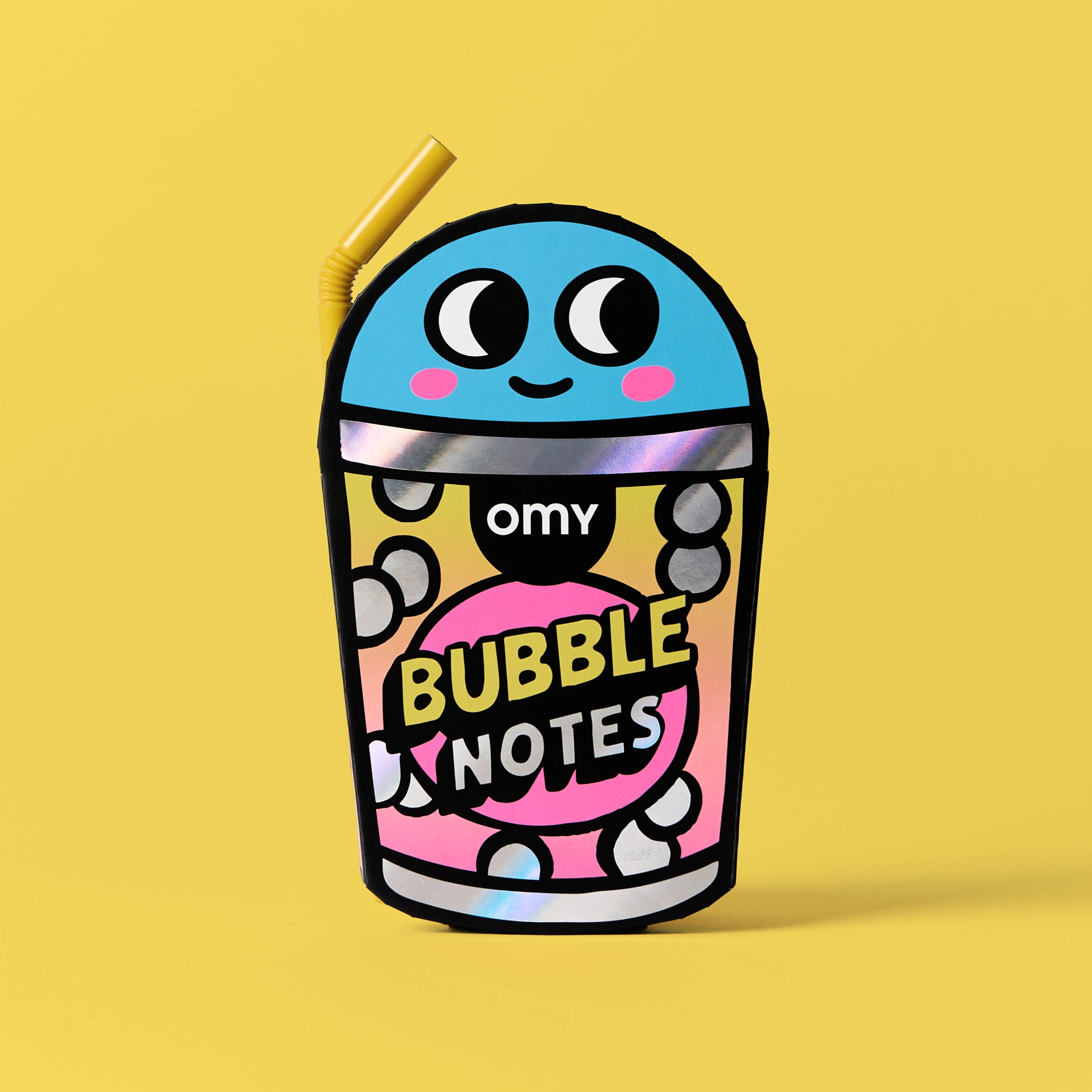 Sticky Notes Bubble OMY – Vue de face du bloc-notes repositionnable en forme de gobelet à bulles avec personnage souriant, fond jaune