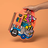 Hand holding the Truck OMY Super Coloring Book shaped like a holographic ice cream truck, coloring book with stickers and 5 wax crayons