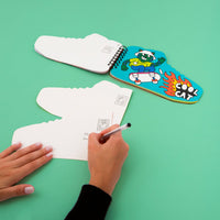Hand writing on the postcard of the Sticker by Number Street OMY book, open to the completed Cool Cat card.