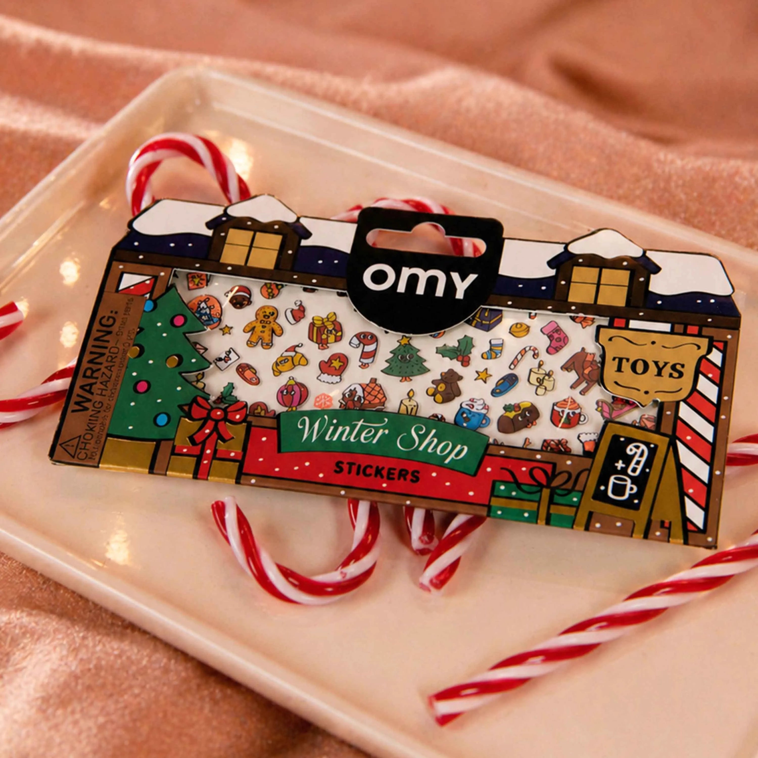 Christmas Boutique Stickers OMY pouch staged with red and white candy canes.