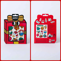 Anverso y reverso de los Fabulous Stickers Noël OMY en un embalaje con forma de regalo rojo y dorado.
