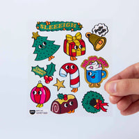 Lámina de Fabulous Stickers Noël OMY con abeto, regalo, campana, bastón de caramelo, bola de Navidad, tronco de Navidad y corona festiva.