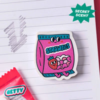 Betty OMY eraser shaped like a strawberry, used on a notebook to erase pencil
