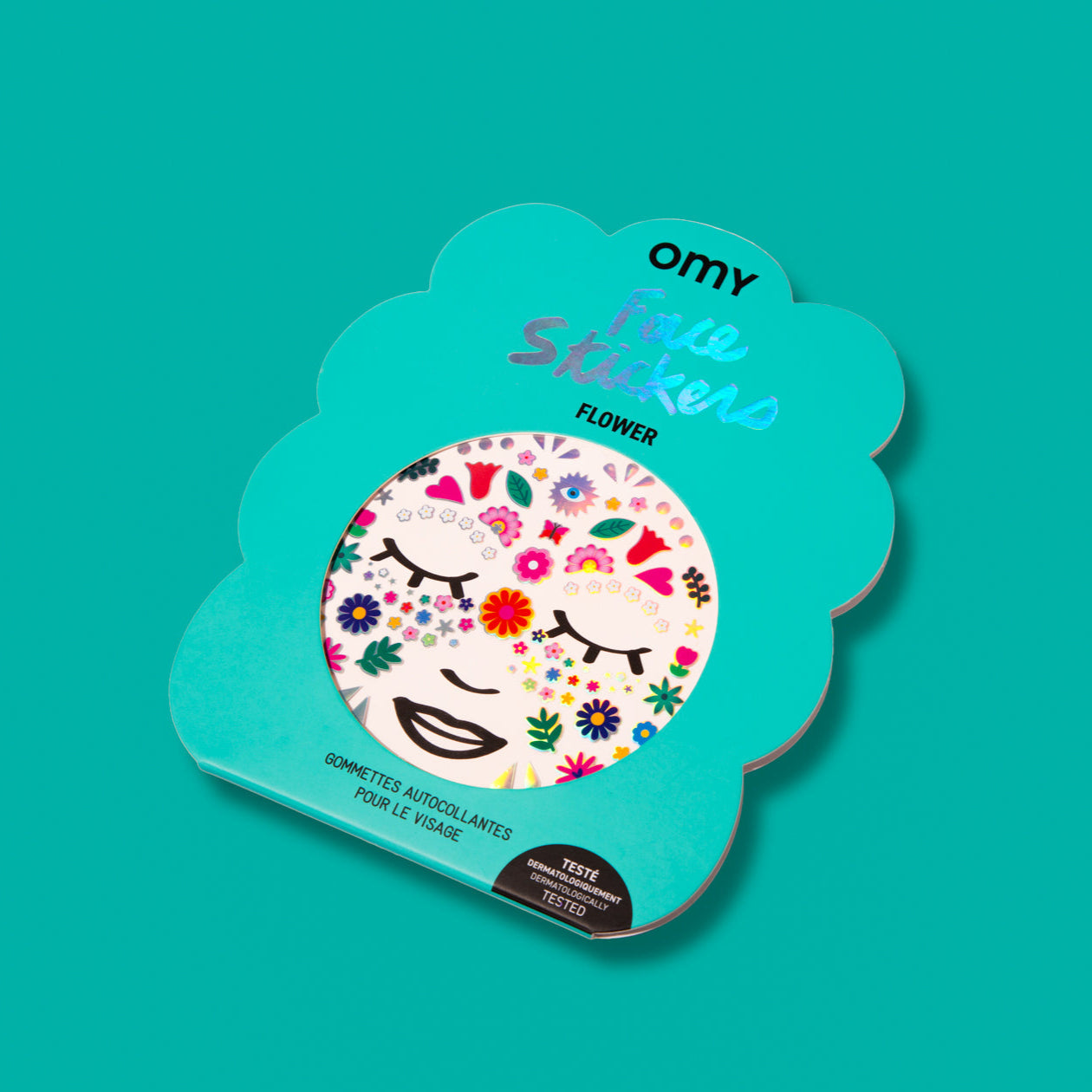 Packaging of the Flower OMY Face Stickers in the shape of a flower, adhesive face stickers, on a turquoise background.