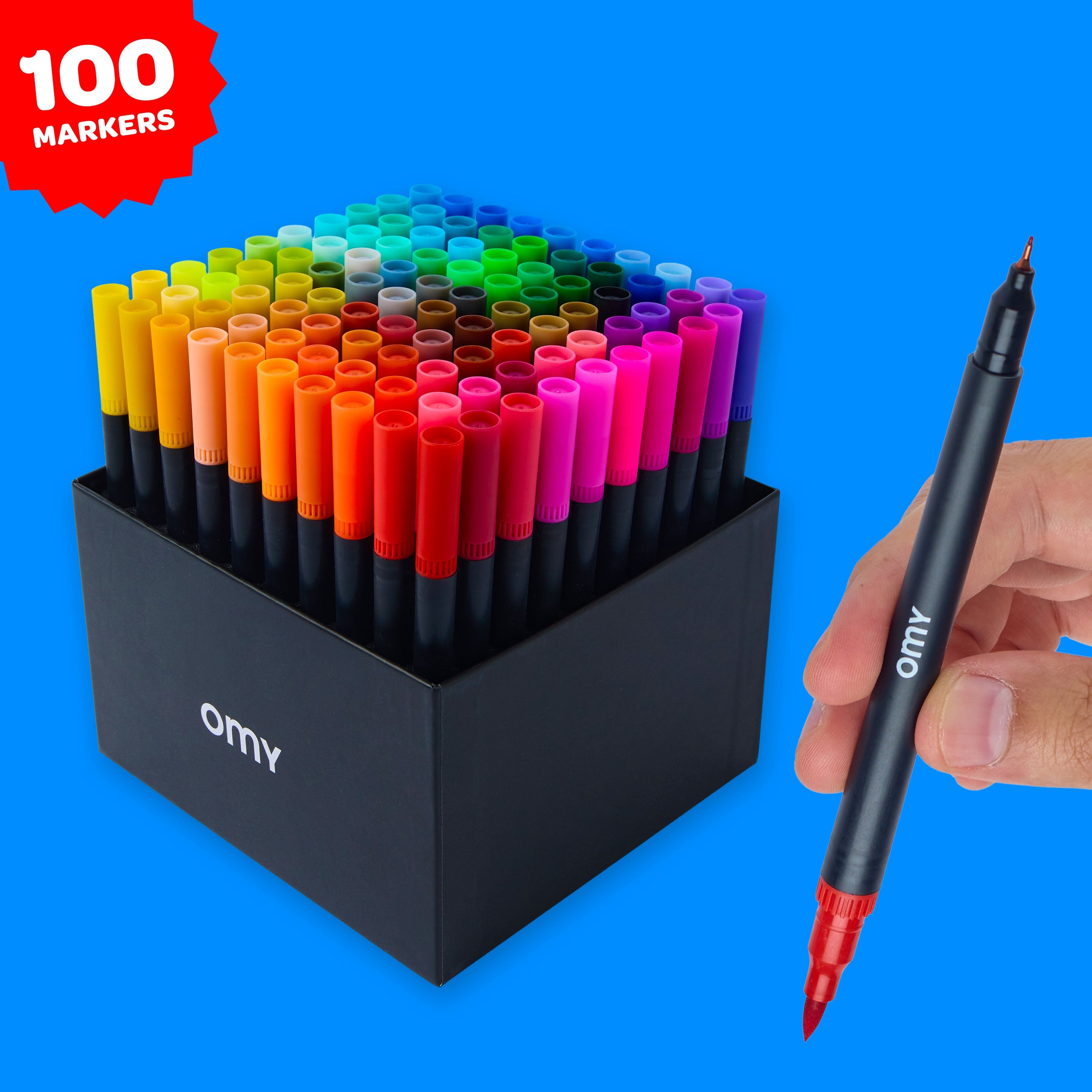 Boîte OMY contenant 100 feutres double-pointe organisés par couleurs, avec aperçu des deux mines.