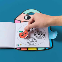 Hand using stickers in the Montessori Stickers Book - Geometric Shapes, educational coloring book by OMY