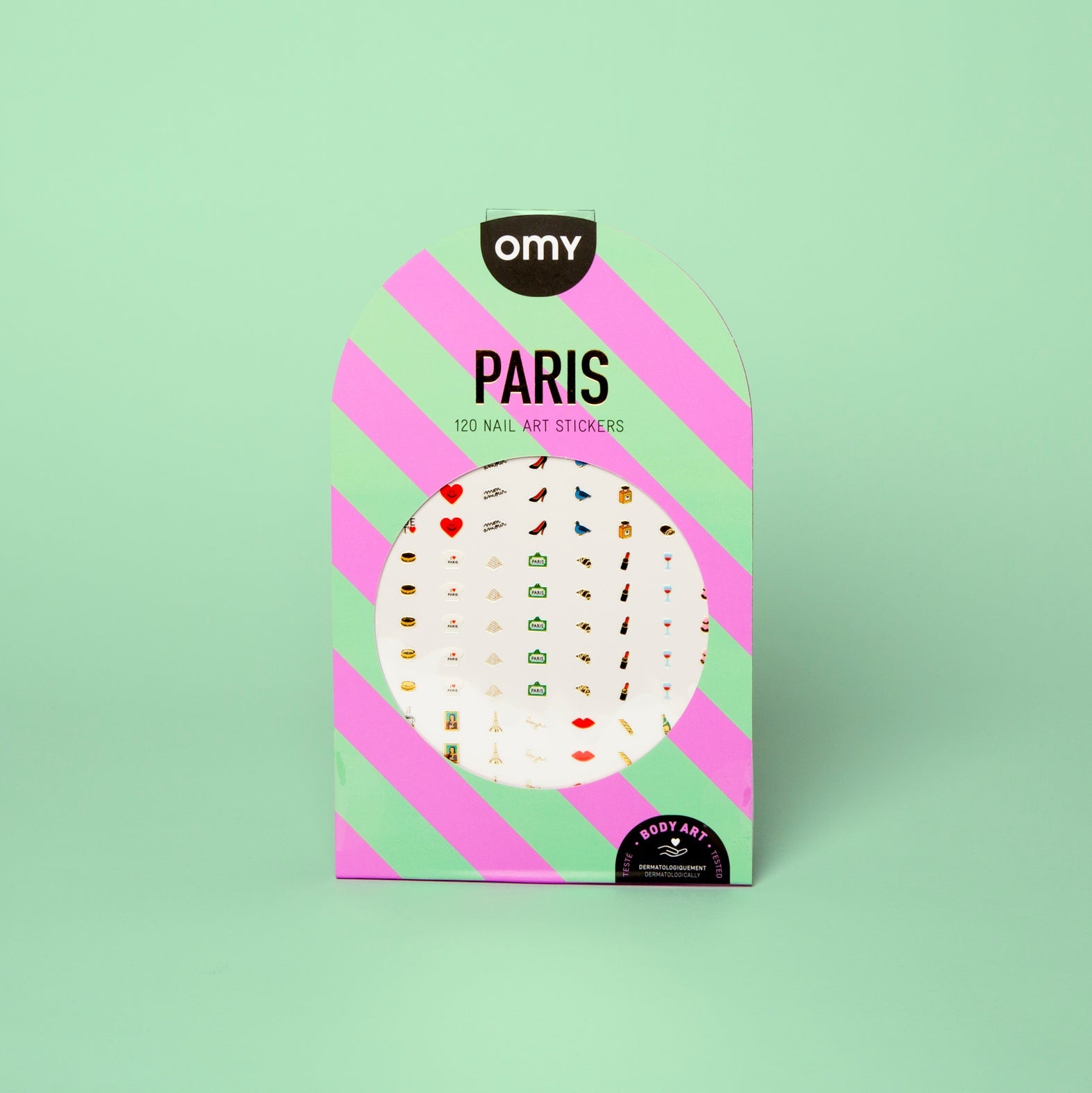 Roze en groen gestreepte verpakking van de 120 Paris OMY Body Art nagelstickers, met hartjes, pumps en lippen, op een mintgroene achtergrond.