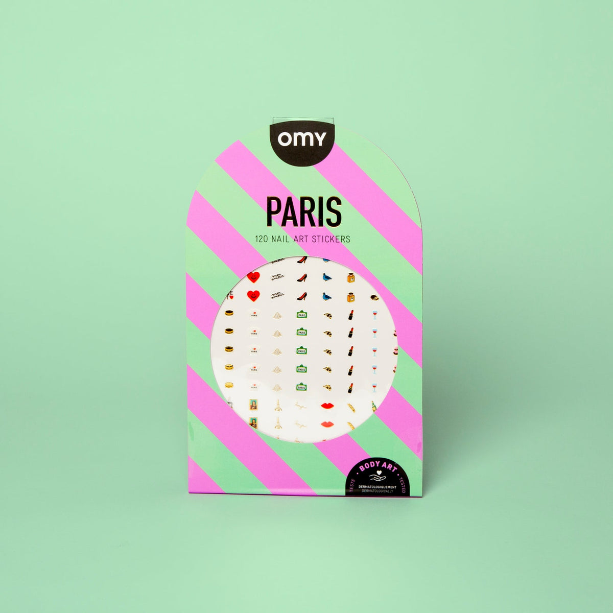 Roze en groen gestreepte verpakking van de 120 Paris OMY Body Art nagelstickers, met hartjes, pumps en lippen, op een mintgroene achtergrond.