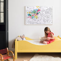 Child admiring the Dinos poster hung on the wall, creative and cheerful setting.