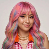 Woman with long wavy hair dyed pink with rainbow streaks, a vibrant hairstyle created with temporary hair chalks.
