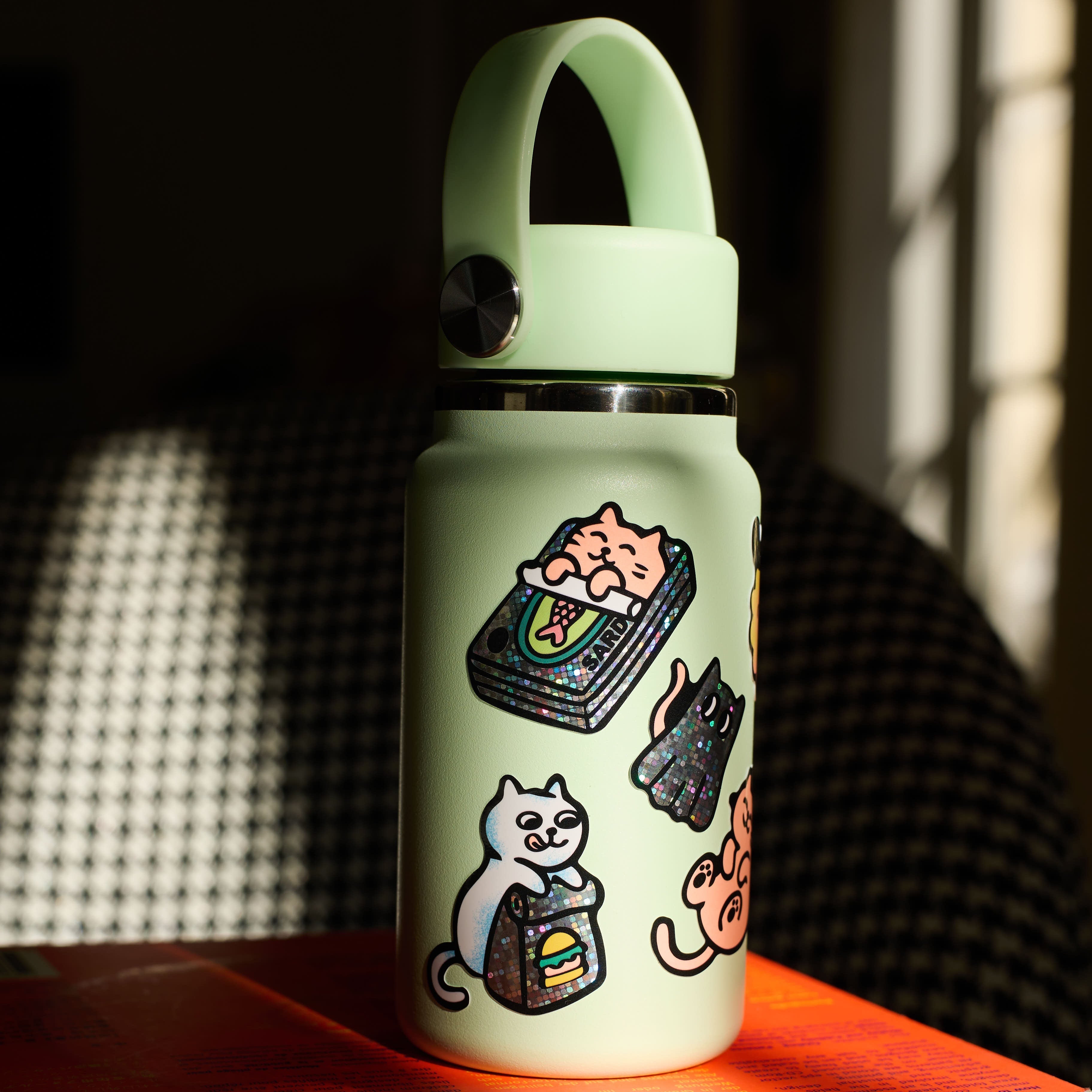 Holographic OMY Fabulous Stickers Kitty cat stickers stuck on a water bottle, durable and waterproof vinyl stickers.