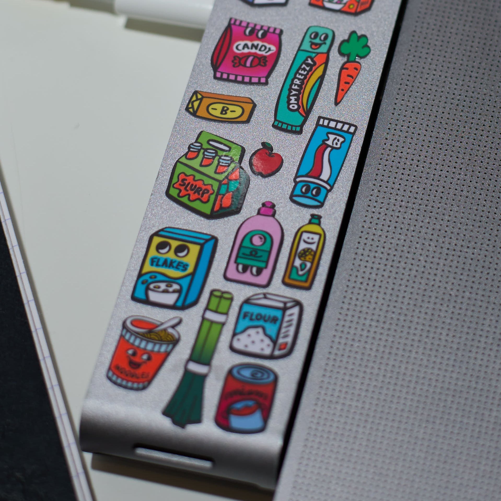 Detail of Supermarket OMY vinyl stickers showing food and everyday products