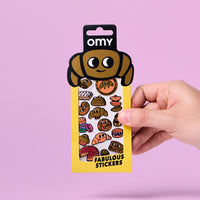 Planche de stickers Fabulous Stickers Croissant OMY, emballage jaune avec illustrations de croissants et pâtisseries, fond rose.
