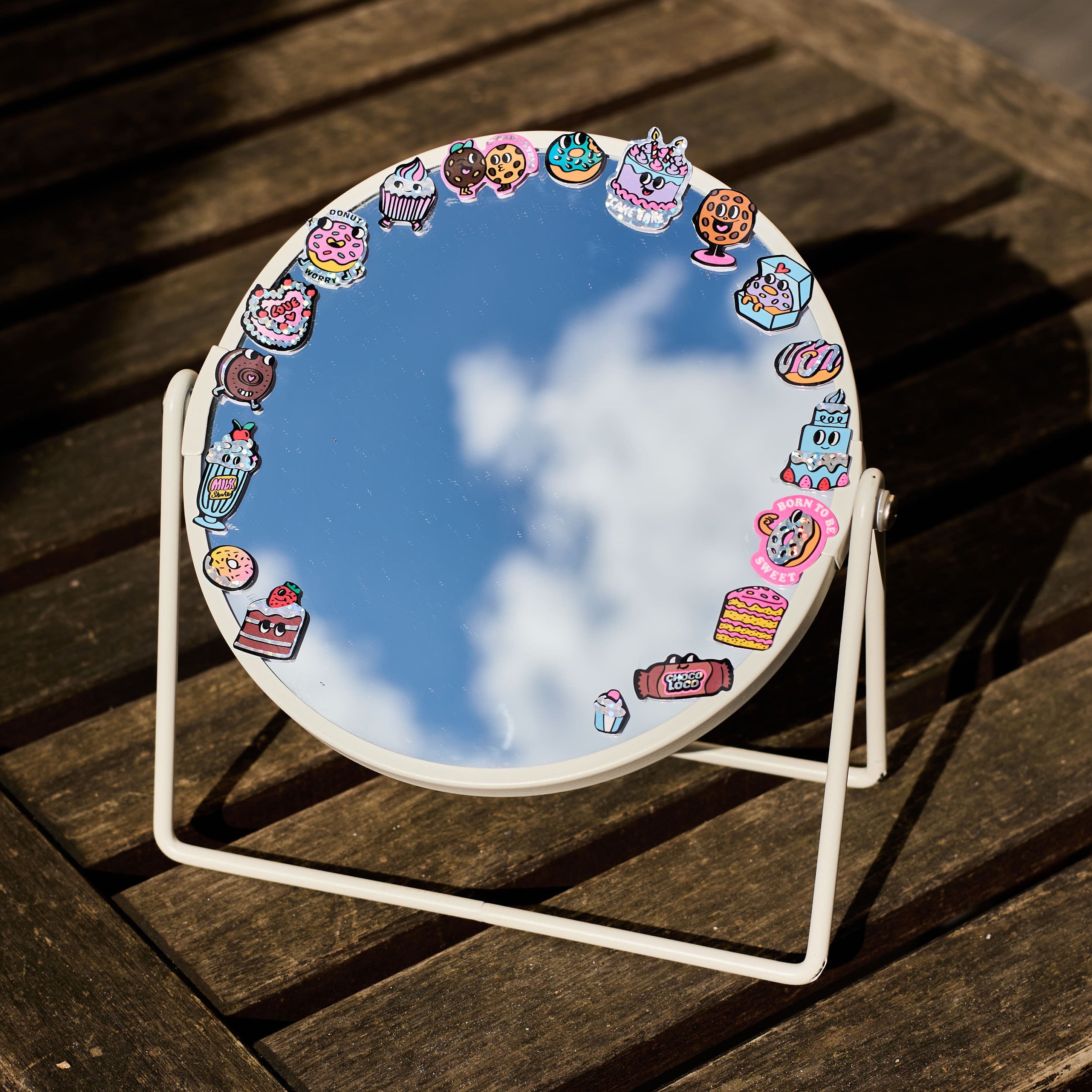 Holographic donut stickers by OMY used to decorate a mirror, a fun and gourmet decor idea