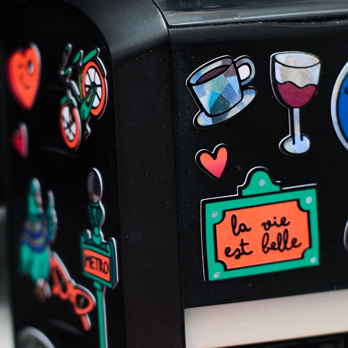 Detail of Paris OMY stickers with a coffee cup, a glass of wine and the message 