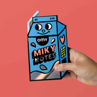 Sticky Notes Miky OMY – Repositionable notepad shaped like a blue milk carton with a straw pen, held in hand